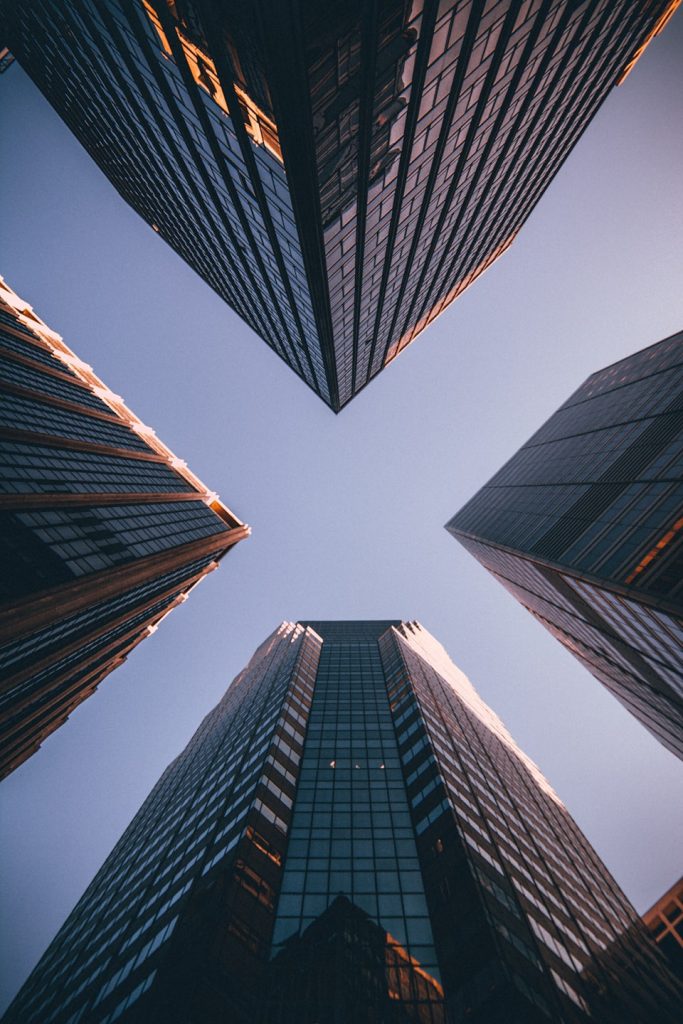 High‑rise office buildings with glass facades to demonstrate the link between global finance providers business loans  aspect 